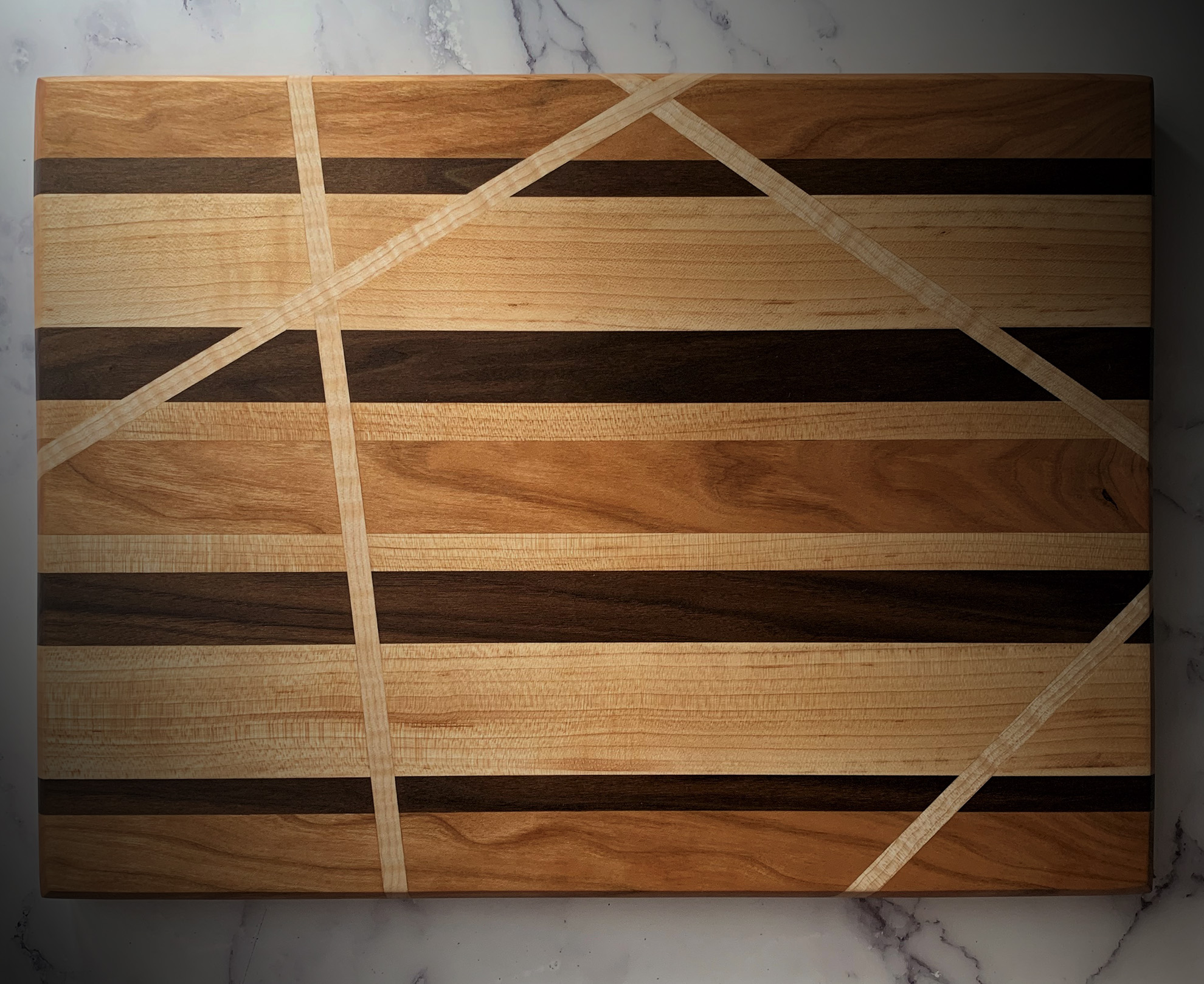 a wooden cutting board with pieces of inlay
